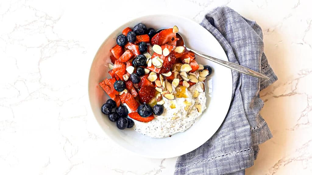 Mediterranean diet for GLP-1 Nausea Whipped protein yogurt bowl with berries, walnuts, cottage cheese, yogurt, chia, hemp, and flax seeds with olive oil and honey