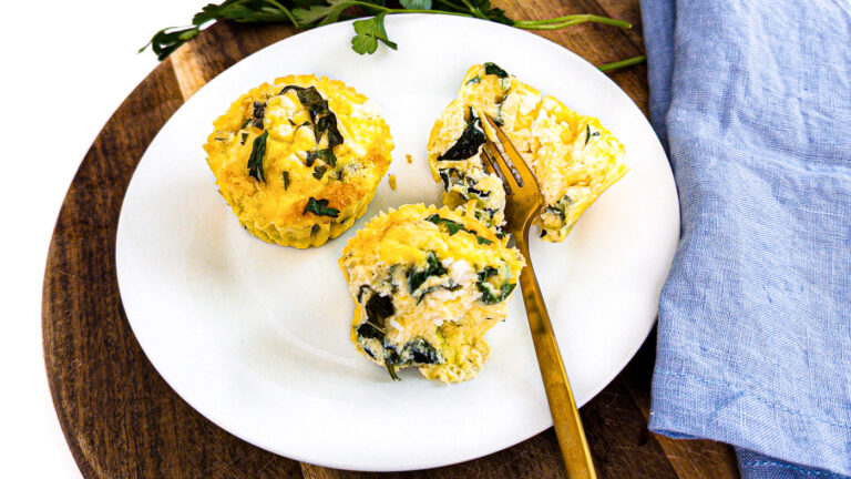 close up of cottage cheese egg bites on a plate with a fork
