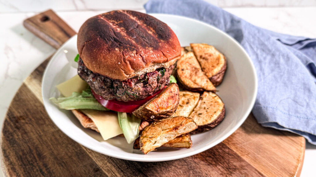 Zesty mediterranean burger with steak fries hero