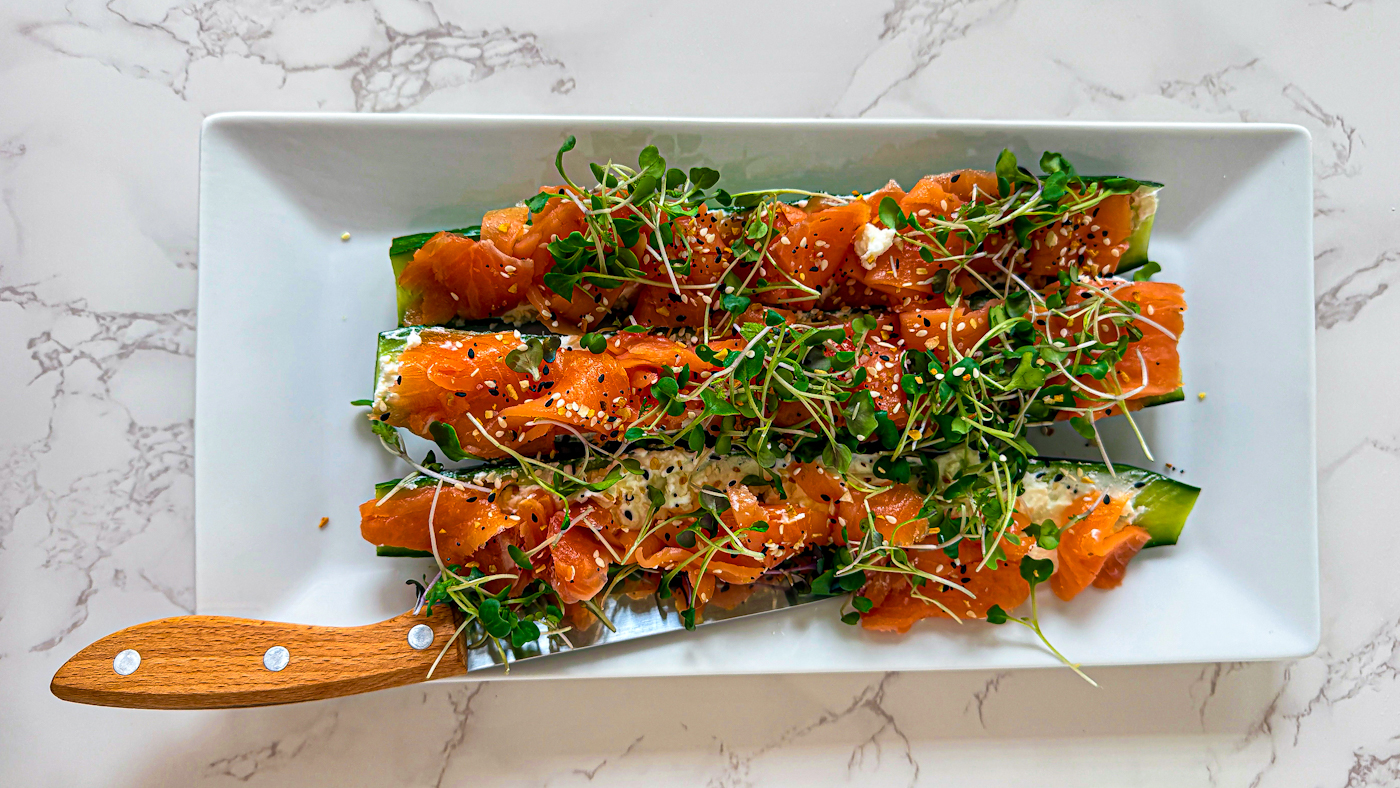 Low Carb 'Sushi' Alternative, cucumbers, salmon, micro-greens on a white platter