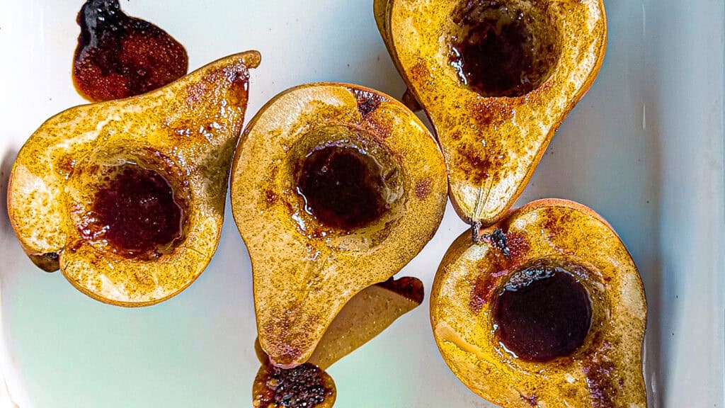 Maple Olive Oil Bosc Pears, close up image of Bosc pears just out of the oven with caramelized maple syrup.