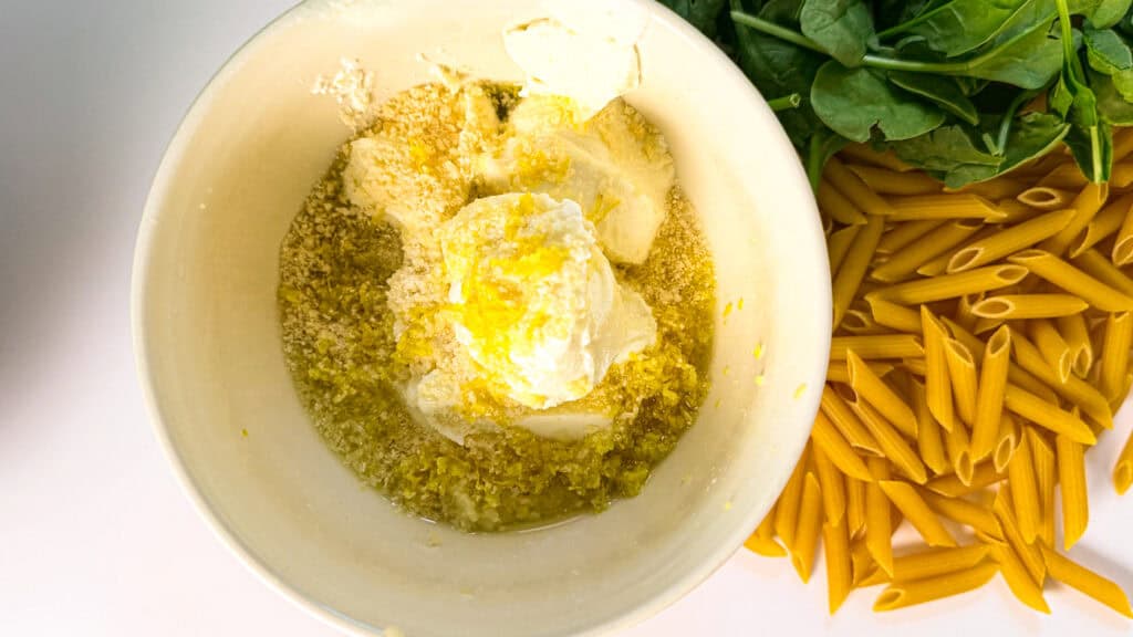 lemon ricotta protein pasta, ricotta, olive oil, lemon zest, lemon juice, seasonings in a bowl.