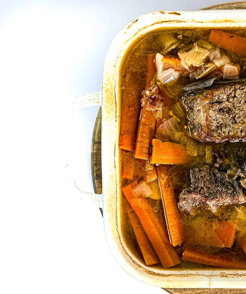 Hearty pot roast with carrots and onions in a savory broth.