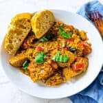 A flavorful dish featuring chicken sausage and orzo pasta, topped with herbs, perfect for a comforting and satisfying meal.
