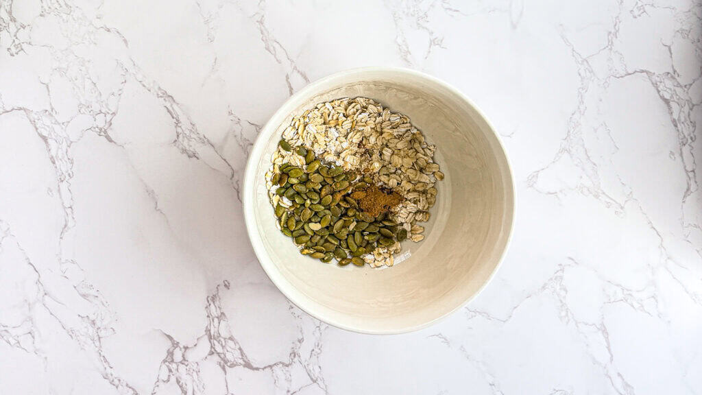 oats, cinnamon, pumpkin seeds in a bowl
