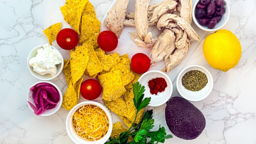Vibrant Mexican ingredients including tomatoes, avocado, lemon, and spices for flavorful dishes.