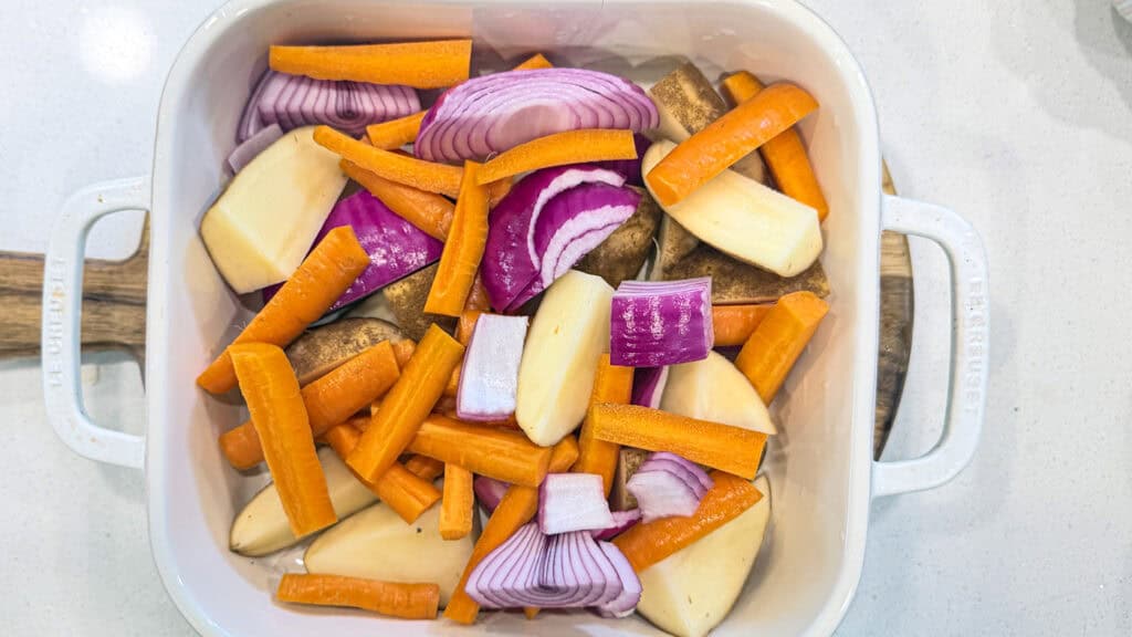 root vegetables in a dish on a cutting board