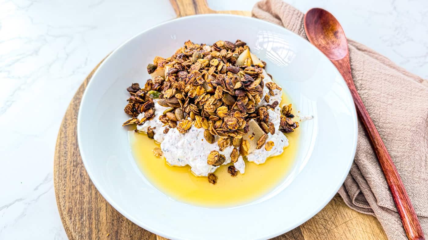 Homemade olive oil granola served with yogurt and honey.