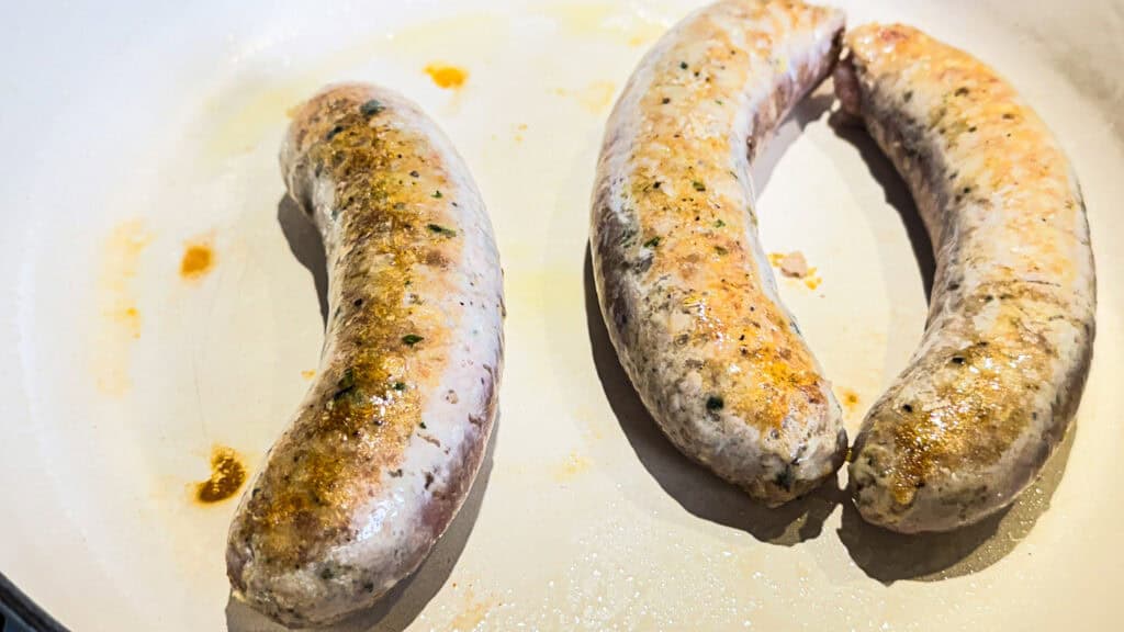Braised Chicken Sausages in a pan