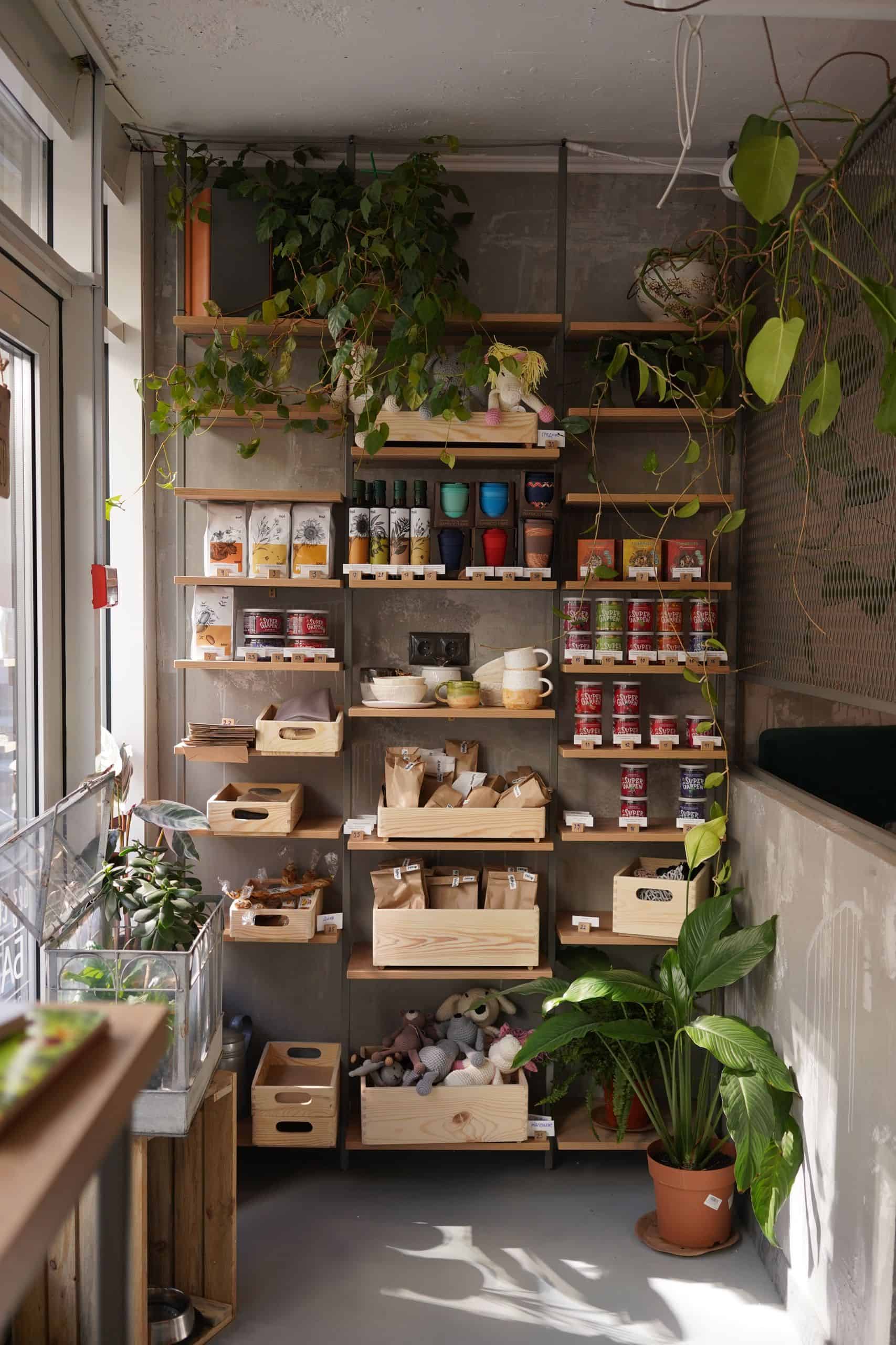 A modern kitchen shelving unit adorned with plants and organized food items, offering a cozy home vibe.