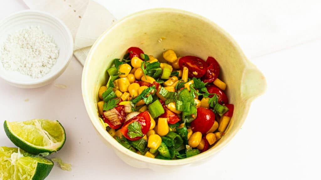 Colorful corn salsa with cherry tomatoes, green onions, and cilantro in a bowl. Manage the Ozempic Gut