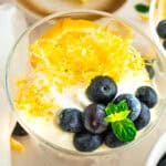 Fresh lemon and blueberry olive oil mousse with whipped cream and mint garnish.
