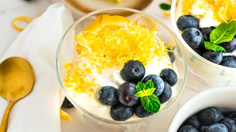 Fresh lemon and blueberry olive oil mousse with whipped cream and mint garnish.