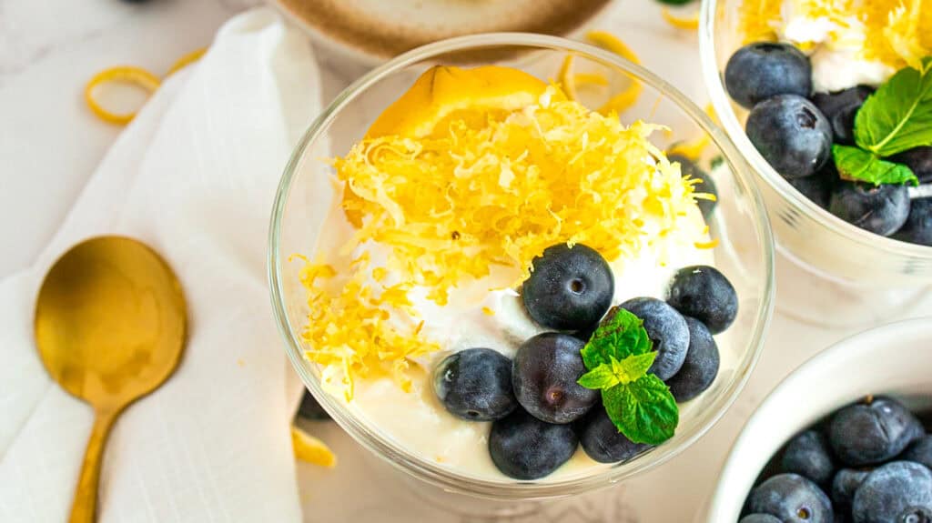 Delicious lemon blueberry parfait with fresh blueberries and lemon zest topping.