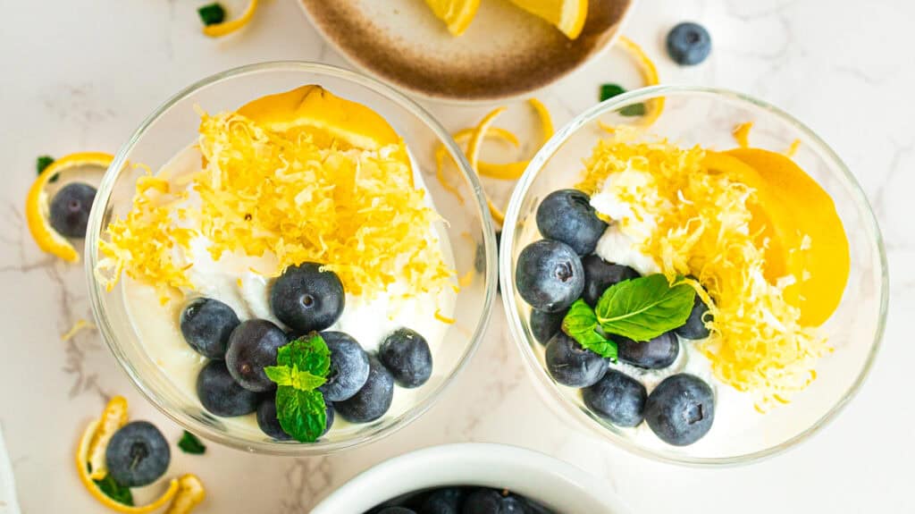 The Mediterranean Diet for GLP-1 Nausea Delicious lemon and blueberry parfaits with whipped cream and mint, perfect for summer desserts.