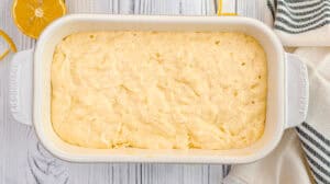 Freshly baked lemon orange olive oil loaf cake in a baking dish.