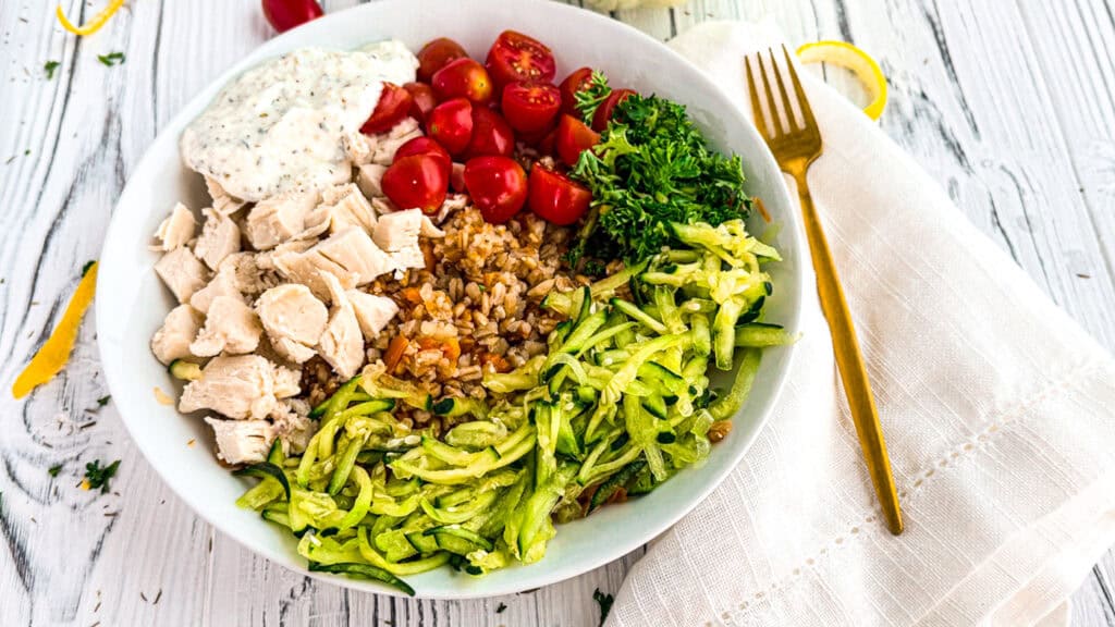 Healthy chicken salad with cherry tomatoes, cucumber, and greens at The Lemon Hearth.