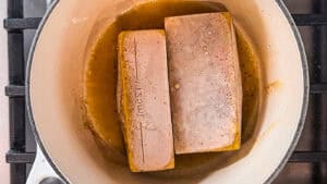 frozen homemade chicken broth heating in a pan