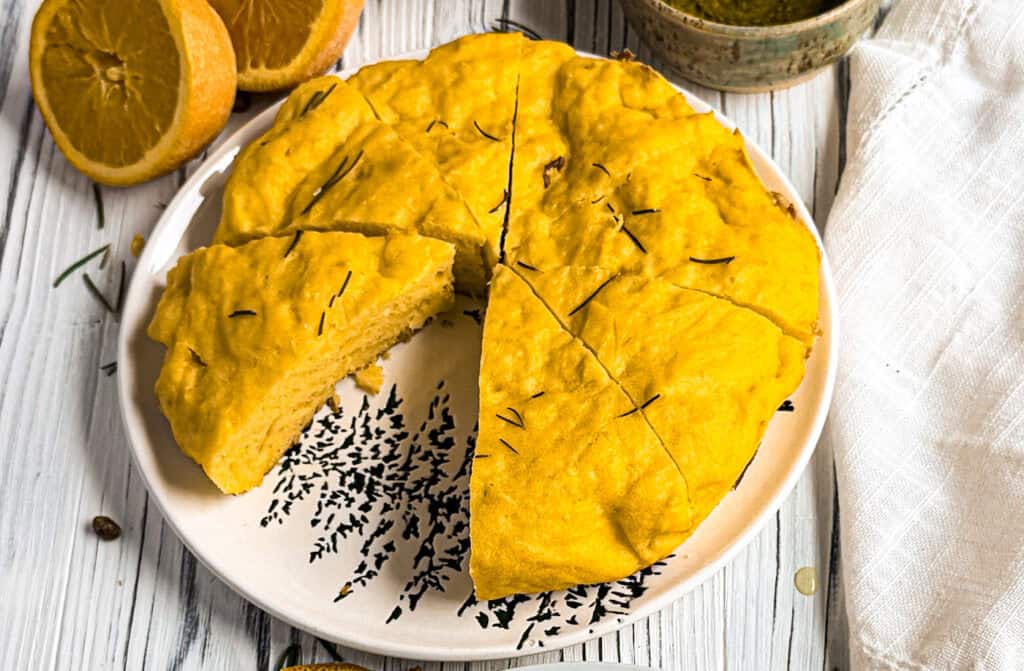 Greek yogurt olive oil cake with oranges on a wooden board.