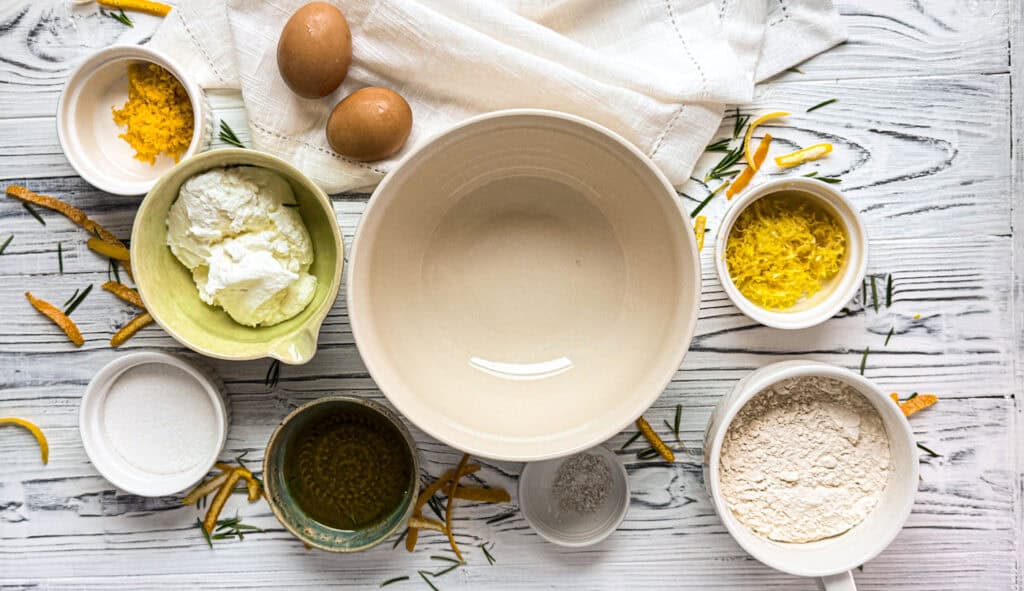Greek yogurt, lemon and orange zest, flour, sugar, olive oil and eggs ready to make a Greek yogurt olive oil cake