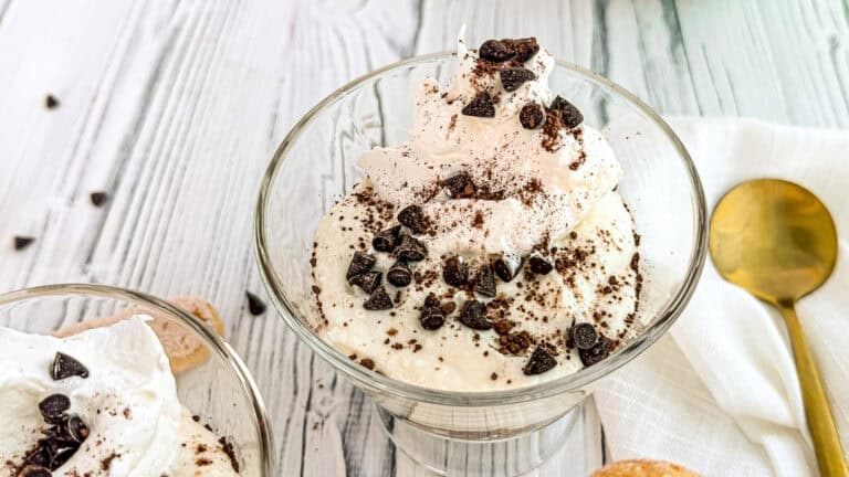 Creamy tiramisu yogurt cups topped with chocolate chips and cocoa powder.