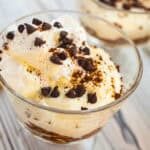 Creamy tiramisu yogurt cups topped with chocolate chips and cocoa powder.