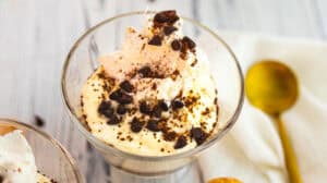 Creamy tiramisu yogurt topped with chocolate shavings in a glass.