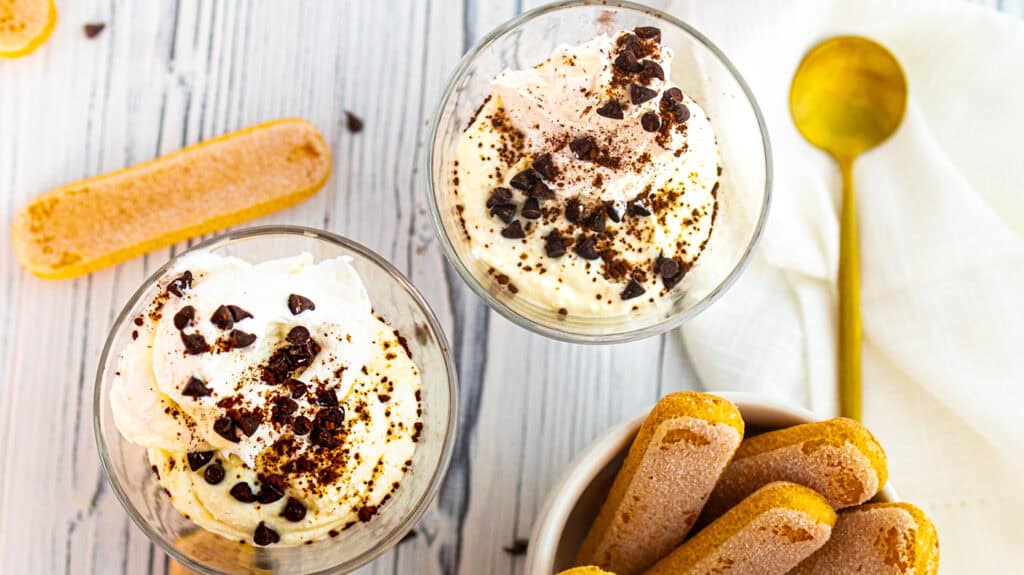 Delicious tiramisu yogurt cups topped with cocoa and chocolate shavings.